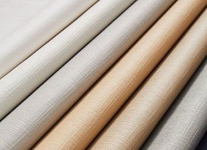 Rolled fabrics in various neutral shades for premium upholstery